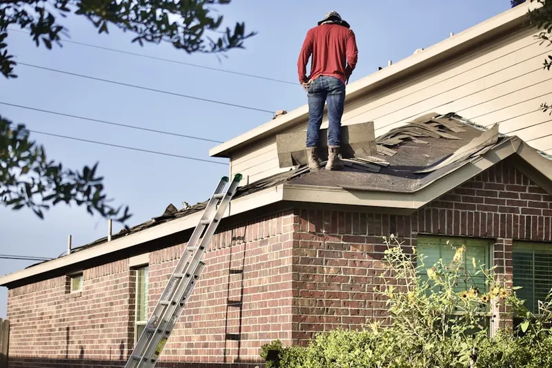 Professional roofer working on a residential roof in Sharpsville